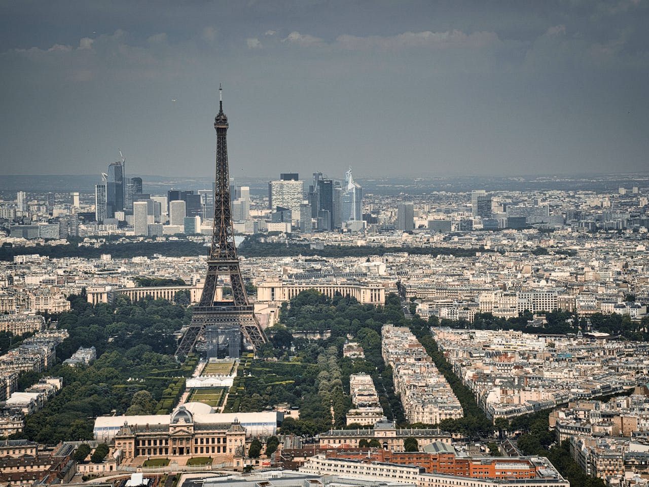 our-services-3 A stunning aerial shot of the Eiffel Tower with the Paris cityscape in the background, showcasing France's iconic landmark.