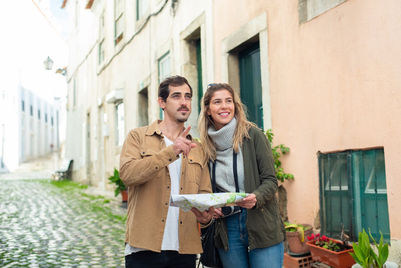 Mastering the First Impression: Your intriguing post title goes here Happy couple exploring a historic city using a map, enjoying a travel adventure together.